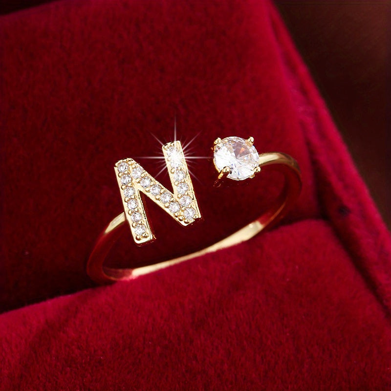 Adjustable Copper Ring With Four-claw Round Zirconia, Featuring The 26 English Letters Of Fashion Trend.