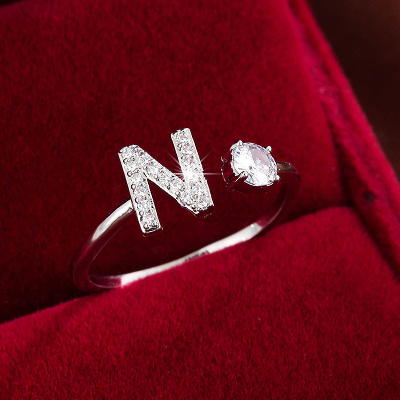 Adjustable Copper Ring With Four-claw Round Zirconia, Featuring The 26 English Letters Of Fashion Trend.