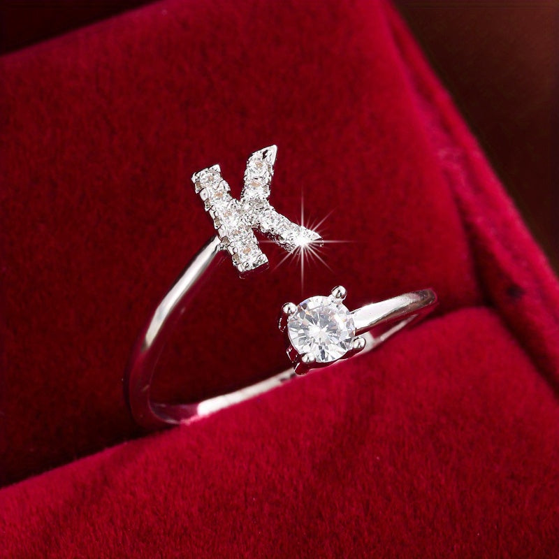 Adjustable Copper Ring With Four-claw Round Zirconia, Featuring The 26 English Letters Of Fashion Trend.