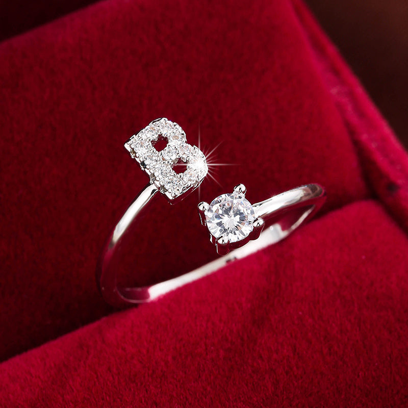 Adjustable Copper Ring With Four-claw Round Zirconia, Featuring The 26 English Letters Of Fashion Trend.