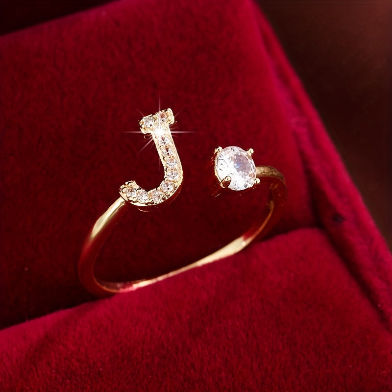 Adjustable Copper Ring With Four-claw Round Zirconia, Featuring The 26 English Letters Of Fashion Trend.