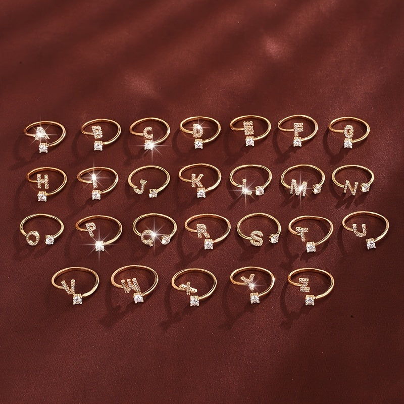 Adjustable Copper Ring With Four-claw Round Zirconia, Featuring The 26 English Letters Of Fashion Trend.