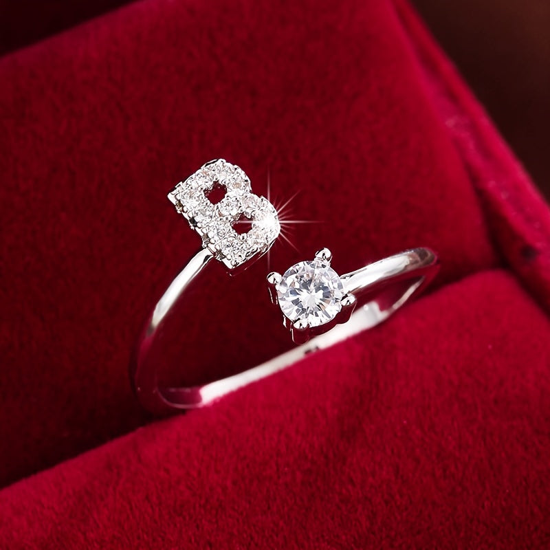 Adjustable Copper Ring With Four-claw Round Zirconia, Featuring The 26 English Letters Of Fashion Trend.